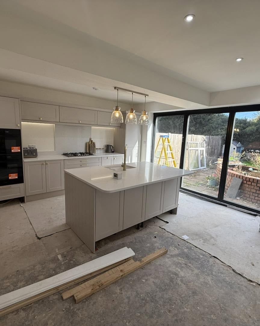 Finished kitchen with island, pendant lights and bifold doors, Bewdley