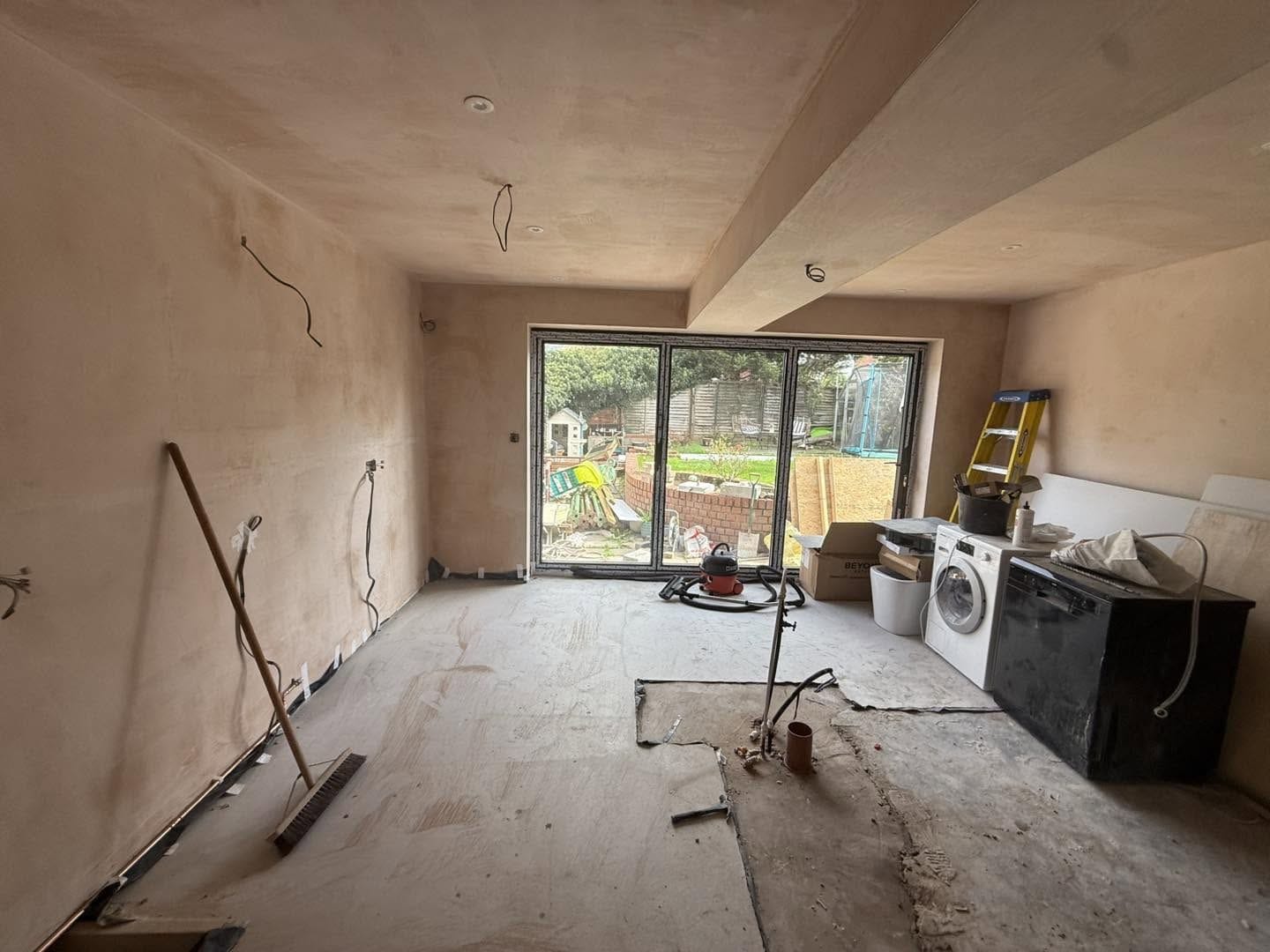 Plastered open-plan room with the new bifold doors, Bewdley