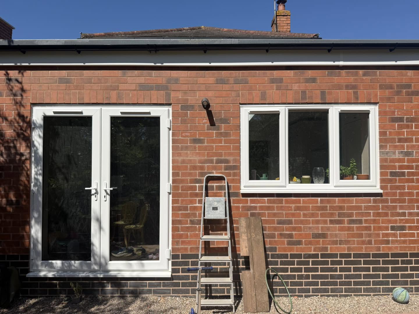External view of the new rear extension in Bromsgrove with brick finish and white French doors