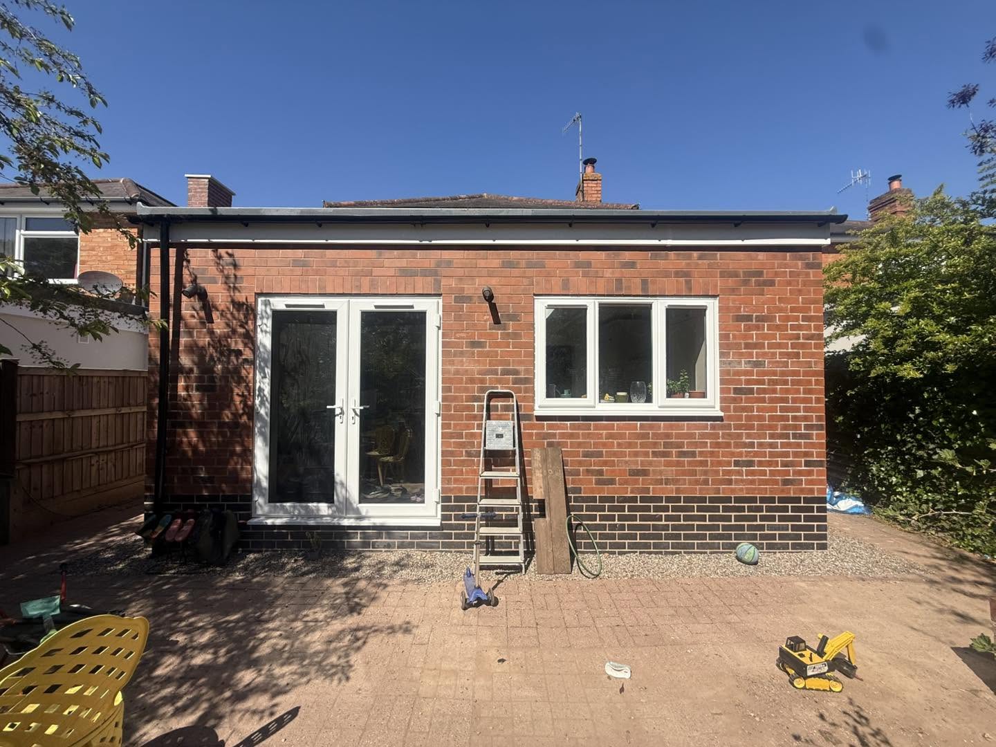 Finished kitchen extension showing shaker cabinetry and marble worktop