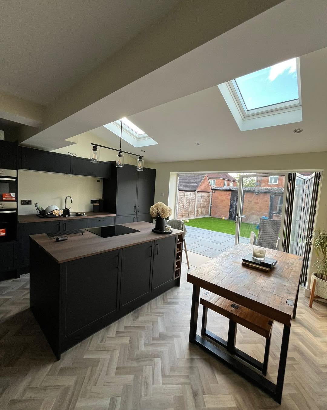 Bi-fold doors fully open showing the seamless transition from kitchen to garden