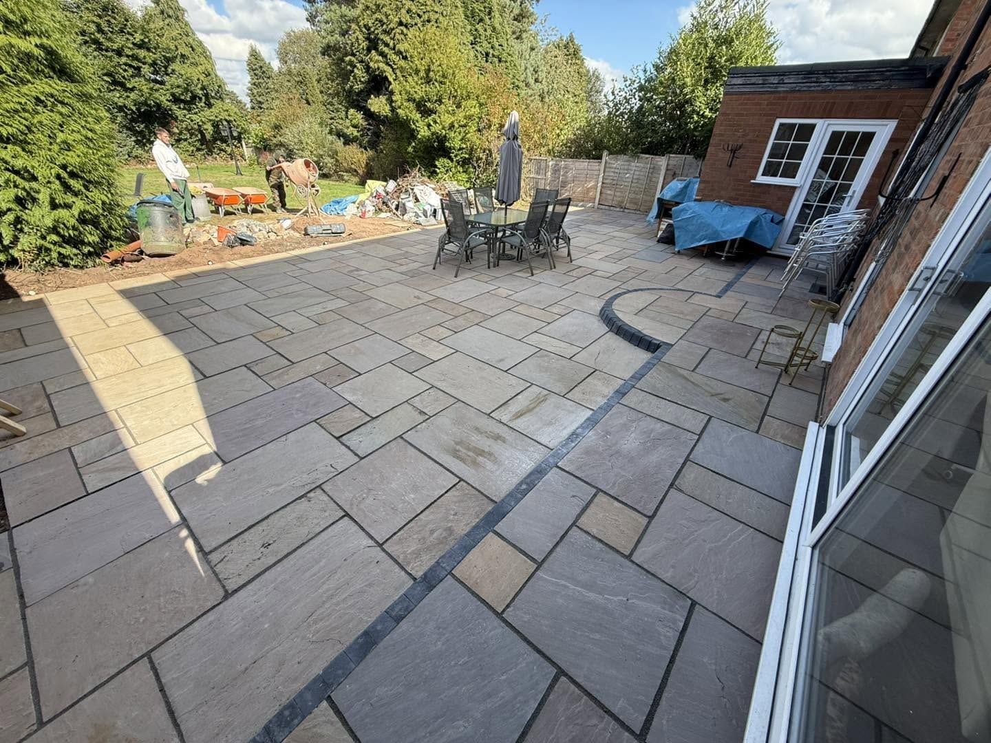 Finished buff sandstone patio with curved step, Kidderminster