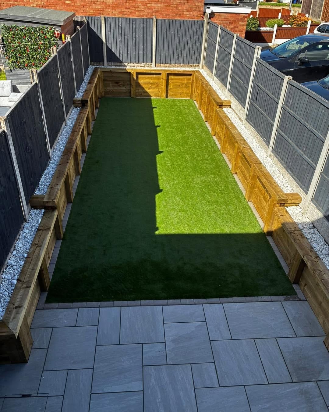 Finished level garden with sleeper retaining walls, lawn and new patio